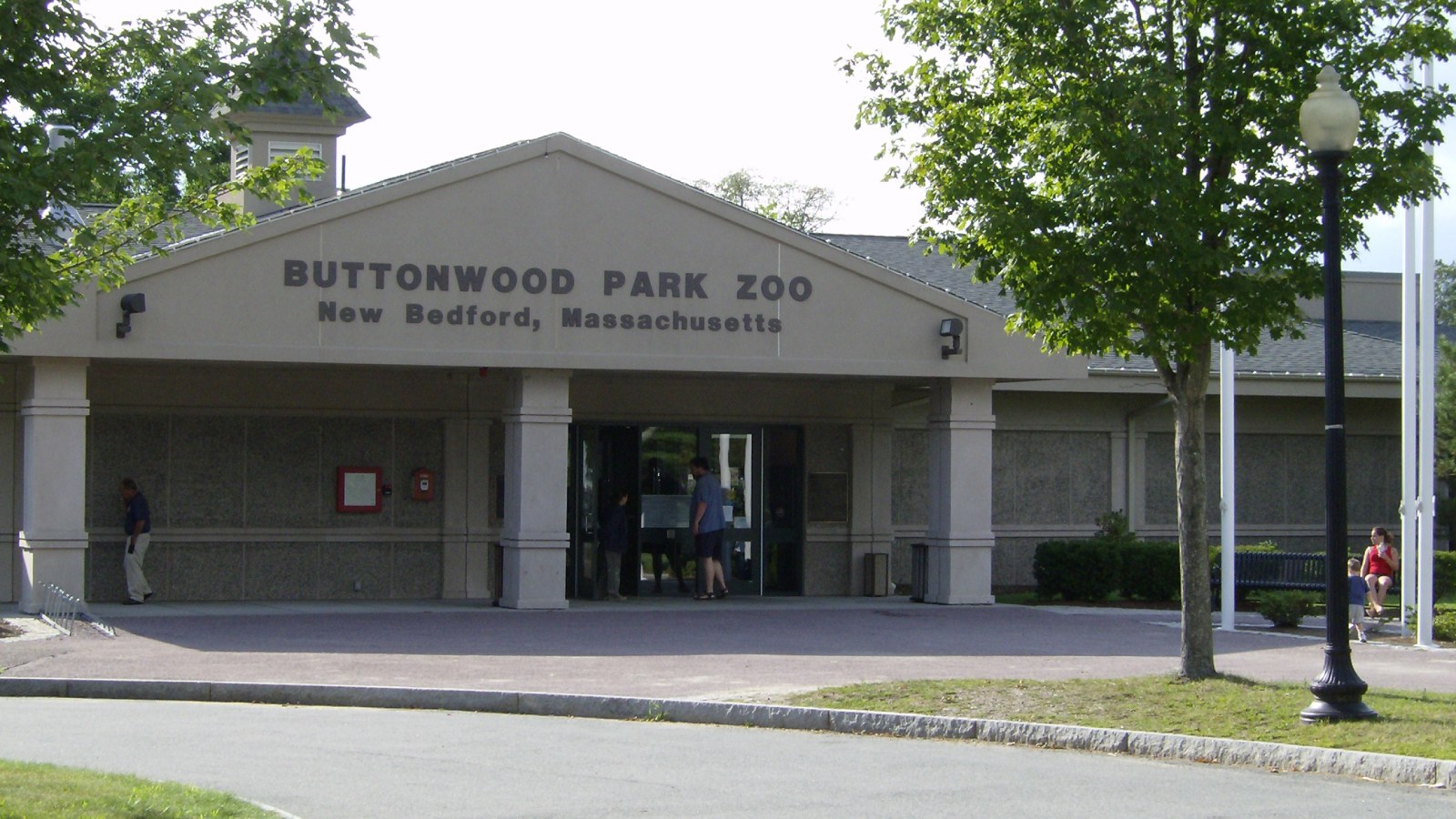 The entrance building of Buttonwood Park Zoo in New Bedford, with the zoo name over the doors
