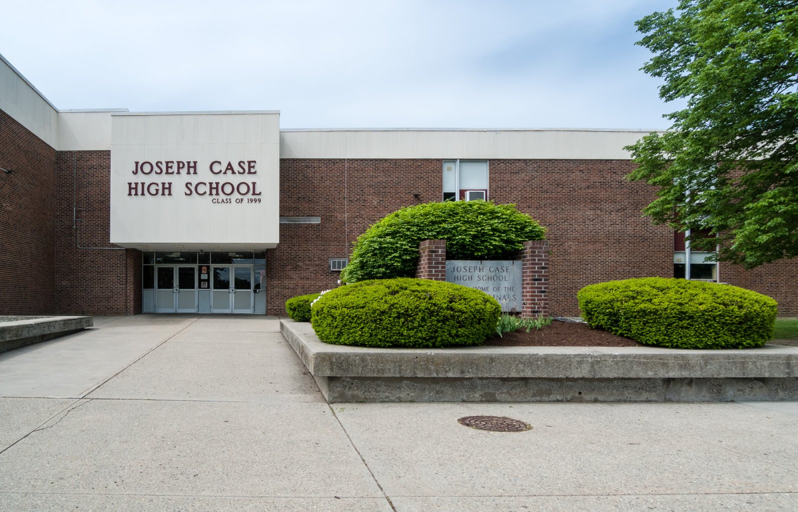 The front entrance of Joseph Case High School in Swansea, a brick building with the school's name over the doors