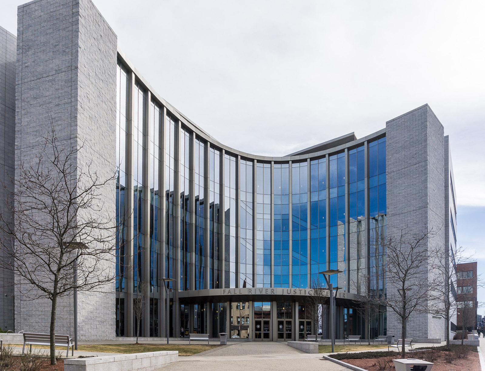 The Fall River Justice Center, a curved glass and stone courthouse on South Main Street