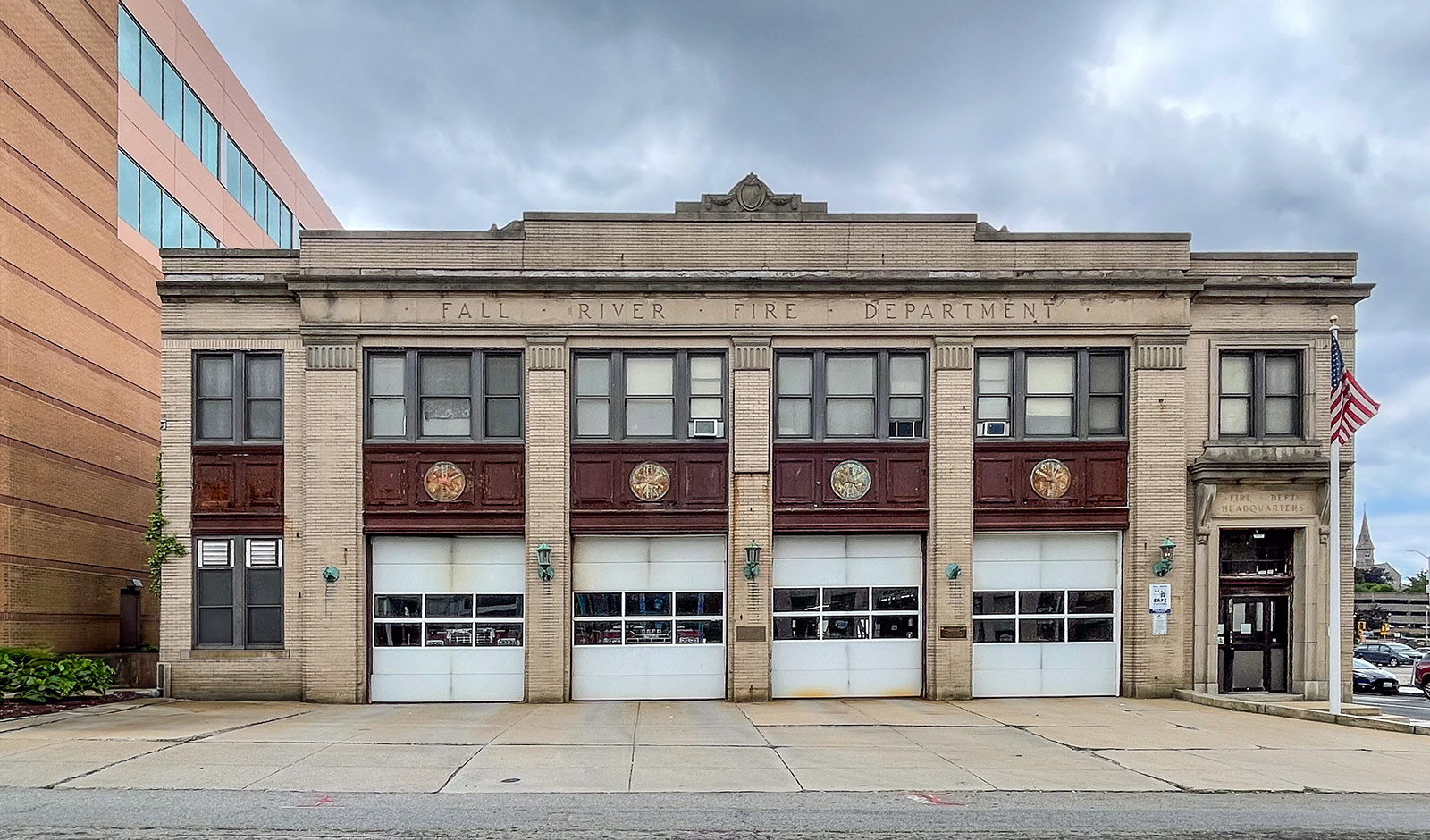 A Fall River Fire Department station, a stone firehouse with four bay doors