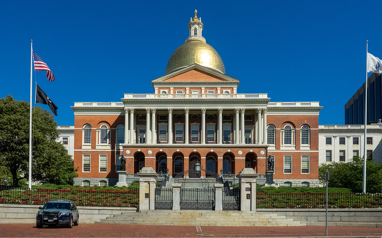 The Massachusetts State House on Beacon Street in Boston, its gold dome under a blue sky