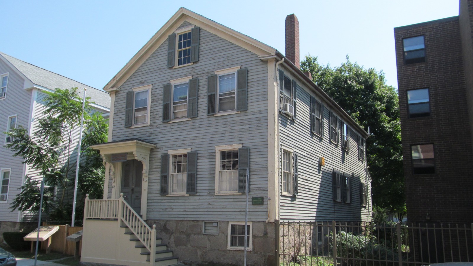 A gray clapboard house with front steps, the Sgt. William H. Carney House in New Bedford
