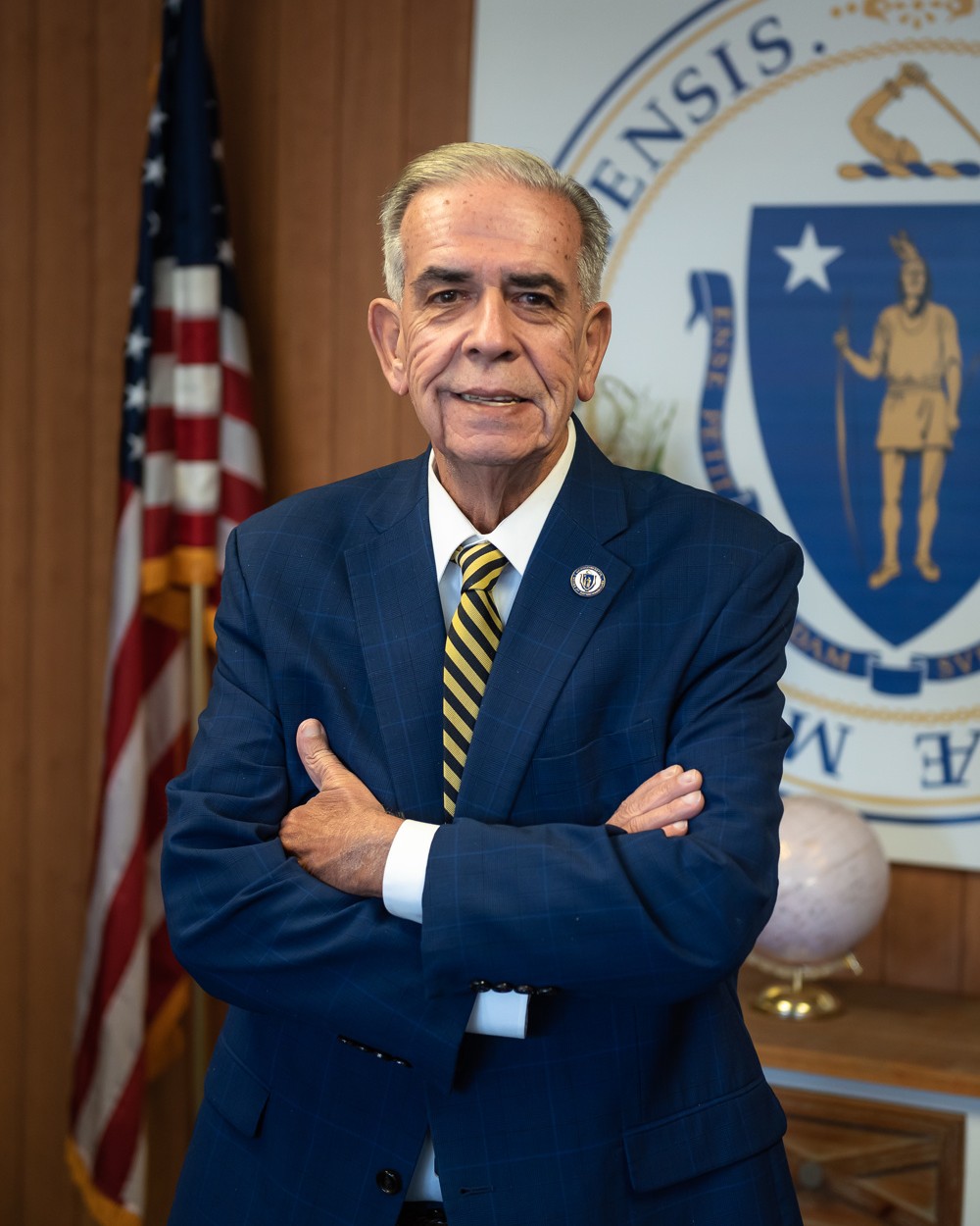 State Rep. Alan Silvia of Fall River, a Democrat who voted for the gas tax holiday in the Massachusetts House, in his official portrait in front of a U.S. flag and the state seal