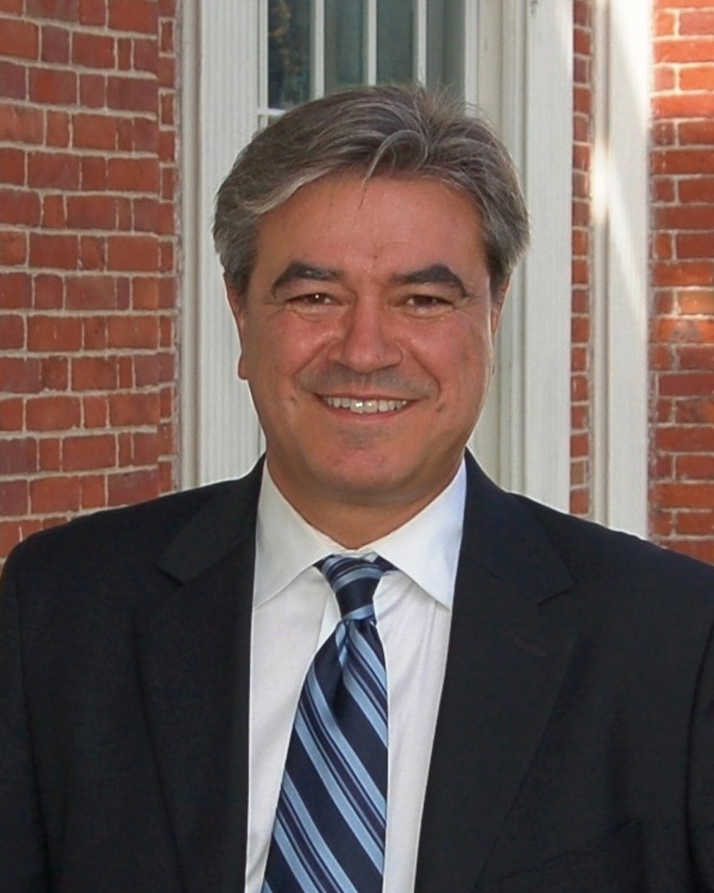 State Rep. Tony Cabral, who announced the New Bedford Police Department road safety grant, in his official portrait in a dark suit and striped tie