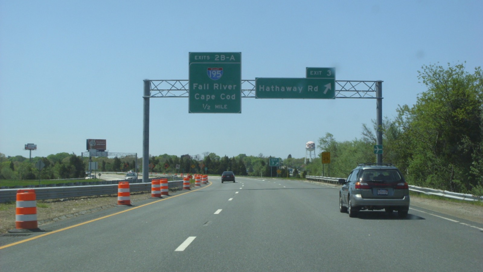 Route 140 southbound in New Bedford, with an overhead sign pointing to the Hathaway Road exit and orange construction barrels along the left lane