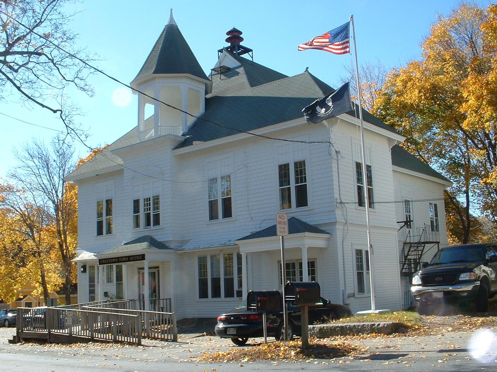 Freetown Town Offices, a white two-story building with a cupola and flag in Assonet