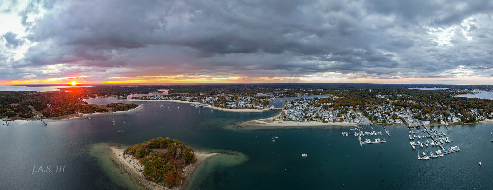 Onset Bay and Wickets Island from the air under a cloudy sunset